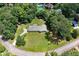 Aerial view showcasing the home's expansive lot, mature trees, and proximity to neighboring homes and a pool at 35 Brookside Ct, Villa Rica, GA 30180