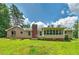 Charming home exterior featuring a brick chimney, screened porch, and well-maintained lawn at 35 Brookside Ct, Villa Rica, GA 30180