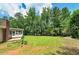 Expansive backyard featuring lush green grass and mature trees, perfect for outdoor activities and relaxation at 35 Brookside Ct, Villa Rica, GA 30180
