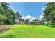 Exterior backyard view showcasing a large grassy area and the house at 35 Brookside Ct, Villa Rica, GA 30180