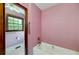 Bathroom featuring a tub, toilet, window, and a support bar at 35 Brookside Ct, Villa Rica, GA 30180