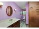 This bathroom has hardwood floors, a vanity, toilet, and a light fixture at 35 Brookside Ct, Villa Rica, GA 30180