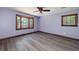 Spacious bedroom features hardwood floors, a ceiling fan, and a large window at 35 Brookside Ct, Villa Rica, GA 30180
