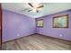 This bedroom has hardwood floors, two large windows, and a ceiling fan at 35 Brookside Ct, Villa Rica, GA 30180
