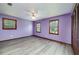 Spacious bedroom with hardwood floors, three large windows, and ceiling fan at 35 Brookside Ct, Villa Rica, GA 30180