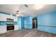 Bright kitchen boasts stainless steel appliances, white cabinets, and new gray-toned flooring at 35 Brookside Ct, Villa Rica, GA 30180