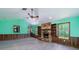 Spacious living room featuring a stone fireplace, wood paneling, new floors, and large windows at 35 Brookside Ct, Villa Rica, GA 30180