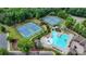 Beautiful aerial view of community pool, clubhouse, and tennis courts for residents at 4590 Sierra Creek Dr, Hoschton, GA 30548
