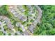 Aerial view of home, set in a neighborhood surrounded by mature trees, with a fenced-in yard at 4590 Sierra Creek Dr, Hoschton, GA 30548