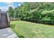 Beautiful backyard with a lush lawn, partially fenced-in, and stairs leading to a deck at 4590 Sierra Creek Dr, Hoschton, GA 30548