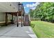 Spacious backyard featuring a well-maintained lawn, privacy fence, patio, and deck access stairs at 4590 Sierra Creek Dr, Hoschton, GA 30548