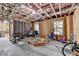 Unfinished basement space with exposed beams, framed walls, and natural light at 4590 Sierra Creek Dr, Hoschton, GA 30548