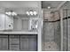 Bathroom featuring a dual vanity with granite countertops and a tiled shower at 4590 Sierra Creek Dr, Hoschton, GA 30548