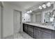 Bright bathroom showcases a large mirror, double sinks and grey cabinets at 4590 Sierra Creek Dr, Hoschton, GA 30548