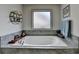 Elegant bathroom features a soaking tub with marble surround and stylish decor at 4590 Sierra Creek Dr, Hoschton, GA 30548