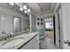 Stylish bathroom featuring double sinks with granite countertops, sleek fixtures, and ample lighting at 4590 Sierra Creek Dr, Hoschton, GA 30548