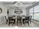 Elegant dining room with tray ceiling, stylish lighting, and large windows offering scenic views at 4590 Sierra Creek Dr, Hoschton, GA 30548