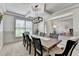 Elegant dining room featuring neutral colors, large window, modern lighting, and view to playroom at 4590 Sierra Creek Dr, Hoschton, GA 30548