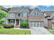 Beautiful two-story brick home featuring a manicured lawn and a two-car garage at 4590 Sierra Creek Dr, Hoschton, GA 30548