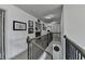 Hallway with carpet flooring, wood and metal railing, and white wall paint at 4590 Sierra Creek Dr, Hoschton, GA 30548