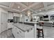 Modern kitchen showcasing an island with granite countertop and stainless steel appliances at 4590 Sierra Creek Dr, Hoschton, GA 30548