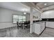 Eat-in kitchen with granite counters, stainless appliances, and gray wood-look floors at 4590 Sierra Creek Dr, Hoschton, GA 30548