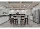 Modern kitchen with an island, granite countertops, stainless steel appliances, and barstool seating at 4590 Sierra Creek Dr, Hoschton, GA 30548