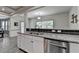 Kitchen featuring stainless steel dishwasher, granite counters, and modern faucet at 4590 Sierra Creek Dr, Hoschton, GA 30548