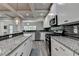 Modern kitchen features granite counters, stainless steel appliances, and subway tile backsplash at 4590 Sierra Creek Dr, Hoschton, GA 30548
