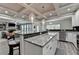 Bright, open kitchen with granite counters, stainless appliances, and an island with seating at 4590 Sierra Creek Dr, Hoschton, GA 30548