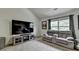 Large living room with vaulted ceiling, tv, and view to backyard at 4590 Sierra Creek Dr, Hoschton, GA 30548