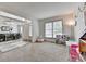 Bright living room with large window, adjacent to the dining area, offers comfortable and versatile living space at 4590 Sierra Creek Dr, Hoschton, GA 30548