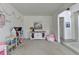 Cozy living room with a dollhouse, storage cabinet, and comfortable seating creating a welcoming space at 4590 Sierra Creek Dr, Hoschton, GA 30548