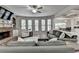 Comfortable living room with a cozy fireplace, built-in shelving, and plenty of seating at 4590 Sierra Creek Dr, Hoschton, GA 30548