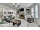 Cozy living room featuring a brick fireplace, built-in shelving, and comfortable seating arrangement at 4590 Sierra Creek Dr, Hoschton, GA 30548