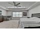 Large main bedroom with a ceiling fan, sitting area, plush carpet, and lots of natural light at 4590 Sierra Creek Dr, Hoschton, GA 30548