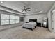 Spacious main bedroom featuring tray ceilings, recessed lighting, large windows, and ample closet space at 4590 Sierra Creek Dr, Hoschton, GA 30548