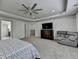 Spacious main bedroom with a ceiling fan, tv, sitting area and ensuite bathroom access at 4590 Sierra Creek Dr, Hoschton, GA 30548