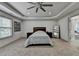 Bright main bedroom with a tray ceiling, fan, carpet, a big window and ensuite bathroom at 4590 Sierra Creek Dr, Hoschton, GA 30548