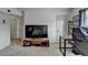 Office space with a vaulted ceiling, grey carpet, a large tv, and two doors at 4590 Sierra Creek Dr, Hoschton, GA 30548