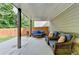 Cozy covered patio featuring wicker furniture and an outdoor seating area at 4590 Sierra Creek Dr, Hoschton, GA 30548