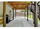 Under deck patio featuring stained wood columns and an outdoor kitchen area with a grill at 4590 Sierra Creek Dr, Hoschton, GA 30548