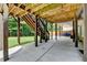 Covered patio area with wooden beams and concrete flooring, perfect for entertaining at 4590 Sierra Creek Dr, Hoschton, GA 30548