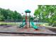 Community playground with slides, climbing structures, and beautiful shady trees at 4590 Sierra Creek Dr, Hoschton, GA 30548