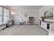 Spacious playroom with plenty of natural light, toys, decor and storage at 4590 Sierra Creek Dr, Hoschton, GA 30548