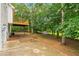 Secluded backyard featuring a spacious patio, mature trees, and a cozy shed at 4958 Alpine Ct, Winston, GA 30187