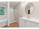 Bathroom with walk-in shower, tub and vanity with a circular mirror at 4958 Alpine Ct, Winston, GA 30187