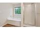 Bathroom featuring a separate tub and shower with glass door at 4958 Alpine Ct, Winston, GA 30187