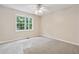 Well-lit bedroom with neutral carpet and large windows showcasing verdant greenery at 4958 Alpine Ct, Winston, GA 30187