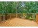 Wooden deck overlooking a serene, lush backyard perfect for outdoor relaxation at 4958 Alpine Ct, Winston, GA 30187